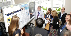 Prof White judging the posters